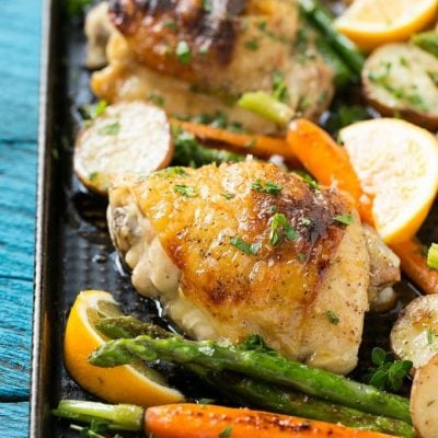 This recipe for lemon thyme chicken is a one pan meal of tender chicken thighs, new potatoes and spring vegetables, all seasoned with a sweet and savory butter and roasted to perfection. #CHHoneyGranules #ad