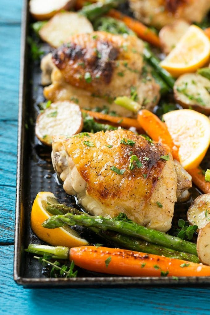This recipe for lemon thyme chicken is a one pan meal of tender chicken thighs, new potatoes and spring vegetables, all seasoned with a sweet and savory butter and roasted to perfection. #CHHoneyGranules #ad