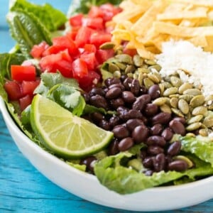 This recipe for mexican caesar salad is crisp romaine lettuce tossed in a creamy cilantro dressing, then finished off with a variety of fun toppings. It's caesar salad in a whole new way that might be even better than the original!