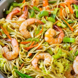 A pan of shrimp chow mein noodles with vegetables.