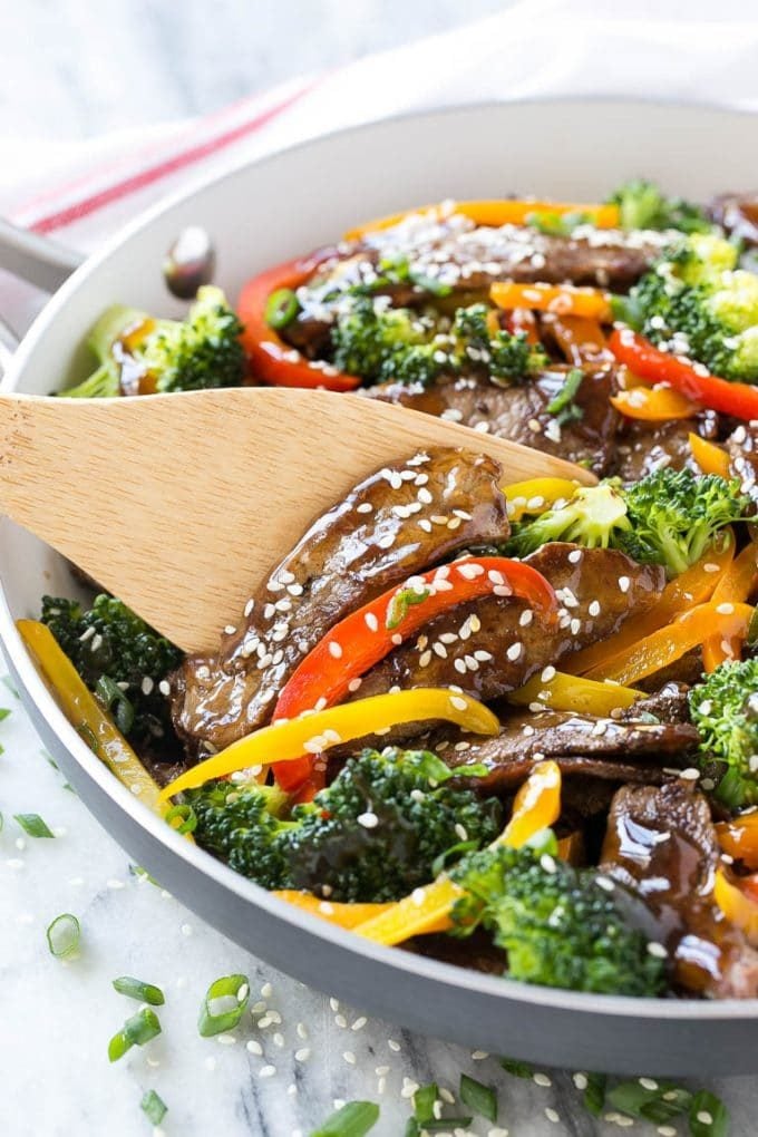 Teriyaki beef stir fry with peppers and broccoli in a skillet.