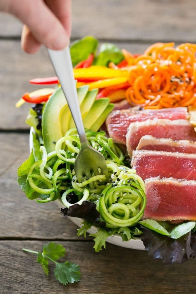Seared ahi tuna salad over a bed of greens with bell peppers, wonton strips and cucumber.
