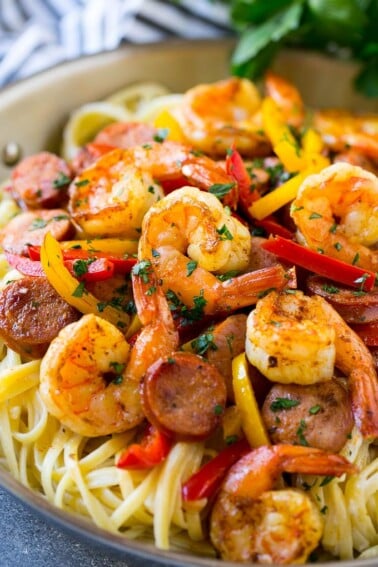 This recipe for Cajun shrimp and sausage pasta is sauteed shrimp and smoked sausage with colorful vegetables, all served over a creamy pasta. Dinner's ready in less than 30 minutes with plenty of bold flavors!