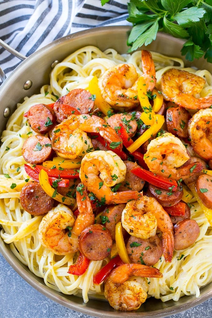 Cajun shrimp pasta is full of sausage and veggies, all served over a creamy pasta.