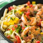 This recipe for Cajun shrimp and sausage pasta is sauteed shrimp and smoked sausage with colorful vegetables, all served over a creamy fettuccine pasta. Dinner's ready in less than 30 minutes with plenty of bold flavors!