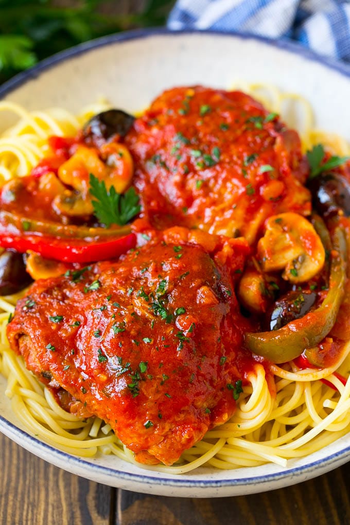 Braised chicken served over spaghetti.