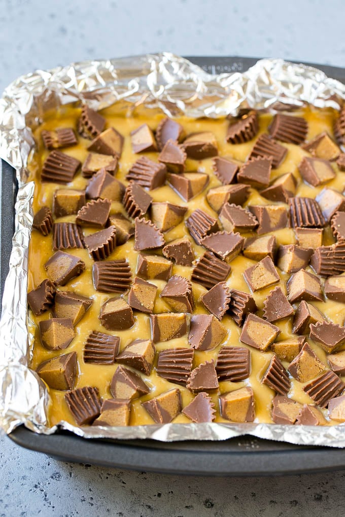 Layered peanut butter chocolate fudge in a square pan.