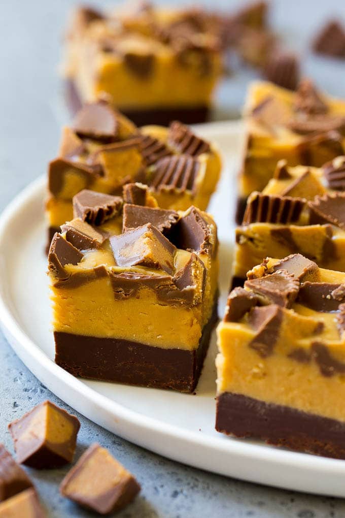 Squares of chocolate peanut butter fudge topped with peanut butter cups.