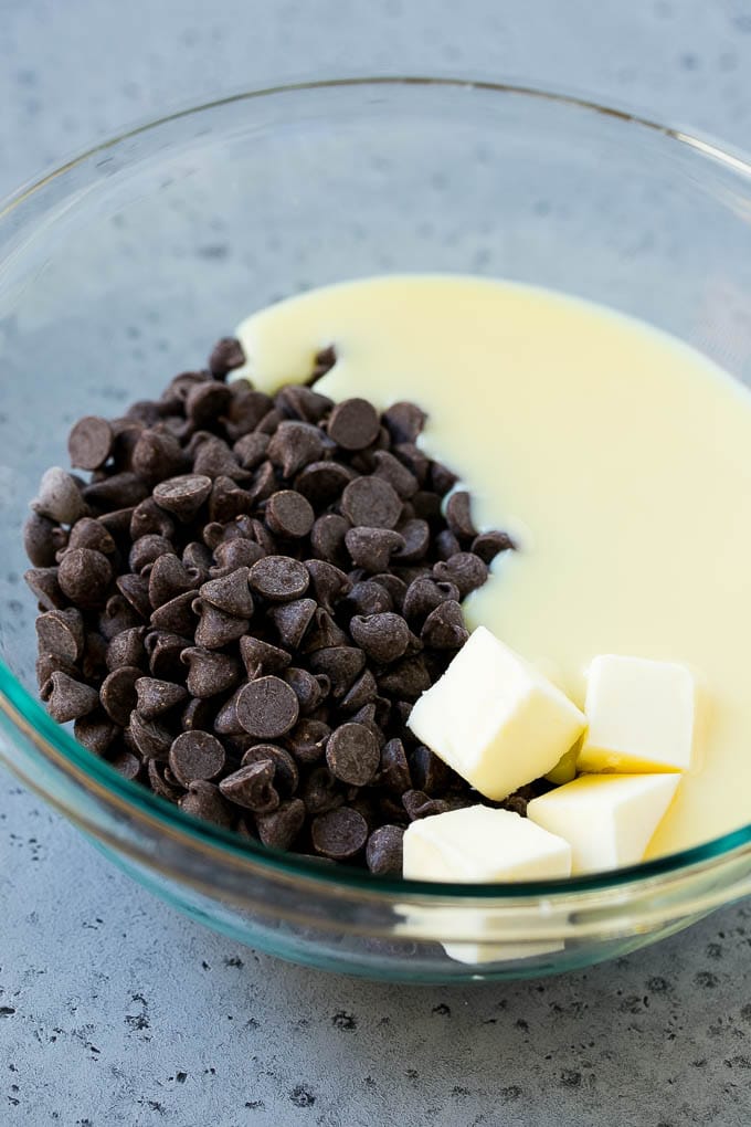 Chocolate chips, condensed milk and butter in a mixing bowl.