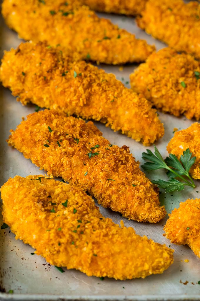 Baked cornflake chicken on a sheet pan.