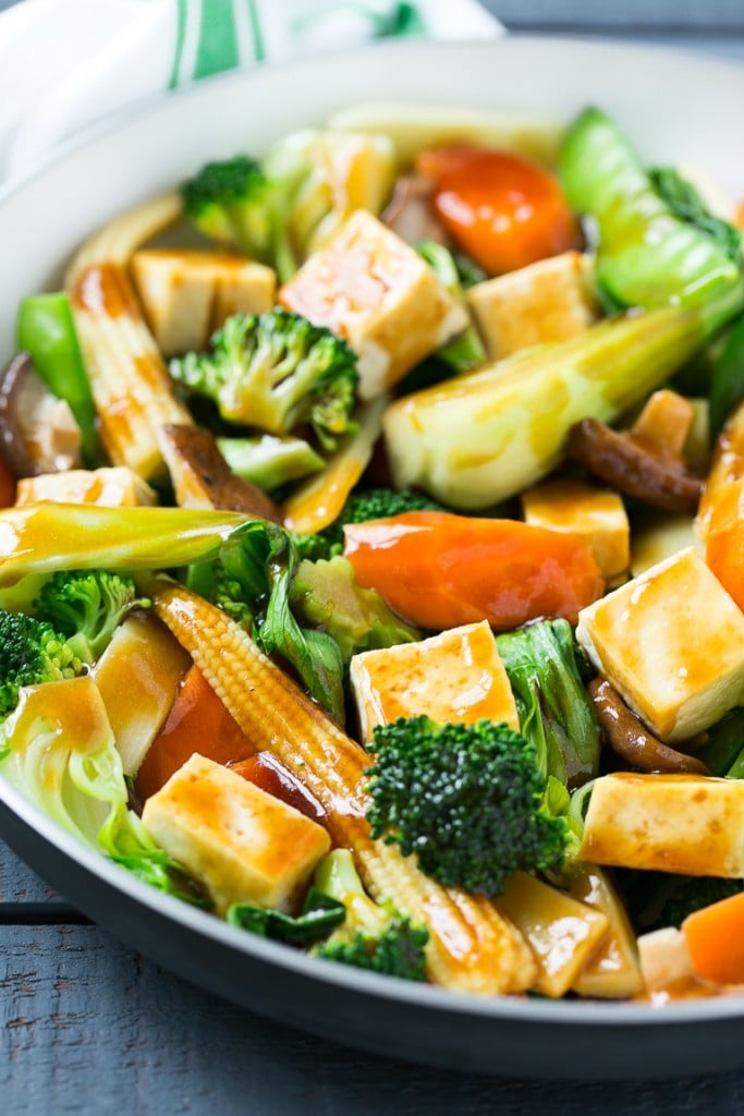 Buddha's delight with broccoli, carrots, tofu and bok choy in a frying pan.