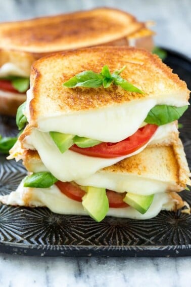 This caprese sandwich recipe is the classic combination of tomatoes, mozzarella and basil with the welcome addition of avocado slices, all sandwiched together between slices of buttery toasted bread. ArtesanoBread AD