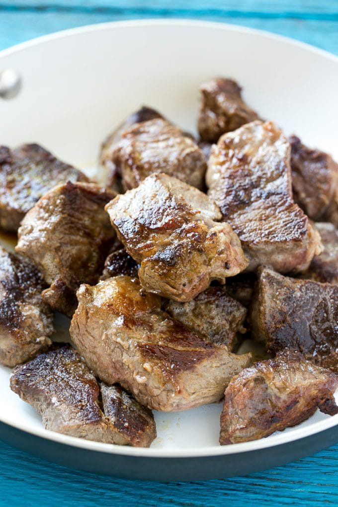 Seared beef cubes in a pan.