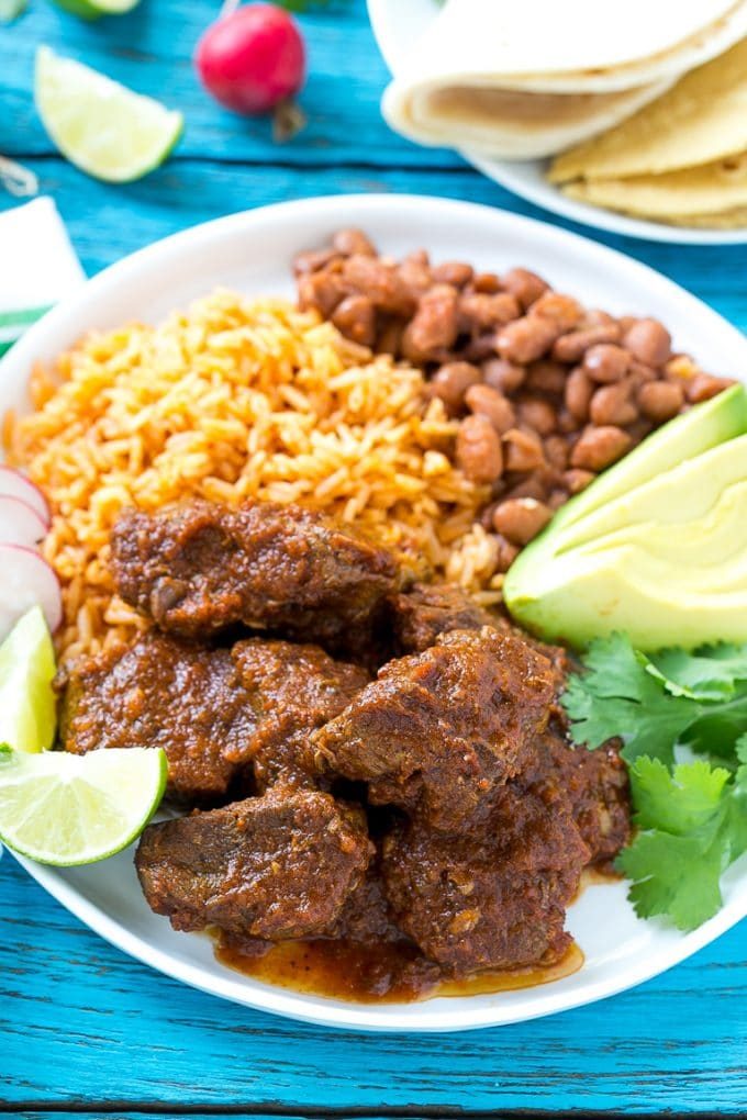 A plate of Mexican beef with rice and beans.