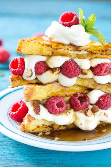 This recipe for cream cheese stuffed french toast is buttery brioche bread dipped in batter and cooked to a golden brown, then sandwiched with a delectable cream cheese, raspberry and almond filling. Finish this brunch delight with a drizzle of syrup for an unforgettable mid-day delight! #ad