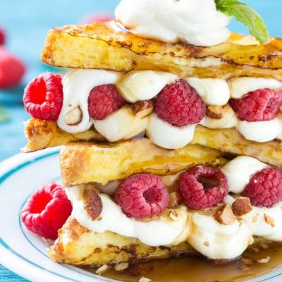 This recipe for cream cheese stuffed french toast is buttery brioche bread dipped in batter and cooked to a golden brown, then sandwiched with a delectable cream cheese, raspberry and almond filling. Finish this brunch delight with a drizzle of syrup for an unforgettable mid-day delight! #ad