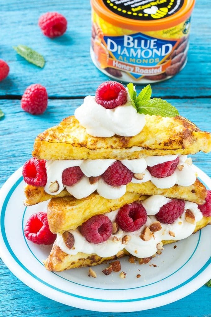 French toast filled with cream cheese and raspberries, then topped with maple syrup.