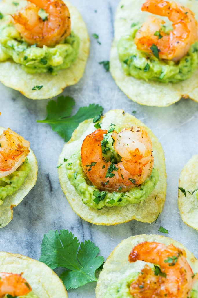Potato chips topped with guacamole and a seared shrimp.