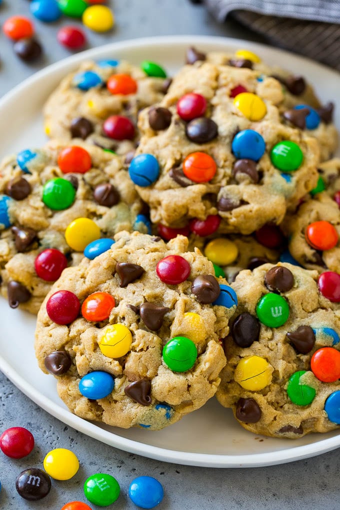 A plate of monster cookies which are made with oats, peanut butter, chocolate chips and M&M's.