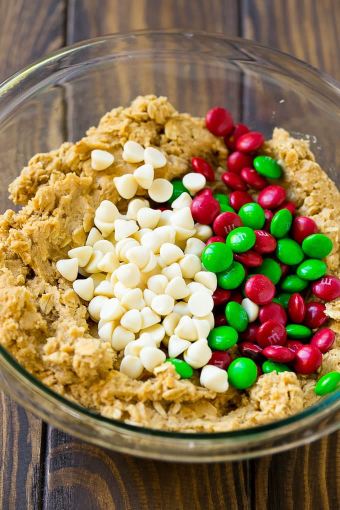 Cookie dough with red and green M&M's and white chocolate chips.