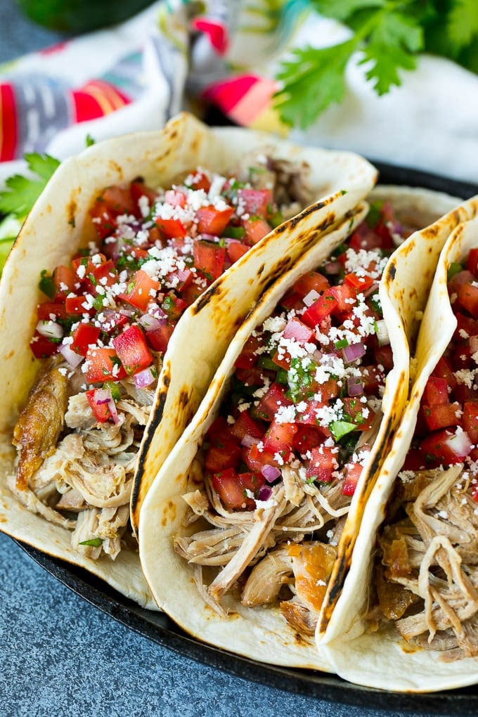 Shredded pork tacos with fresh tomato salsa and cotija cheese.