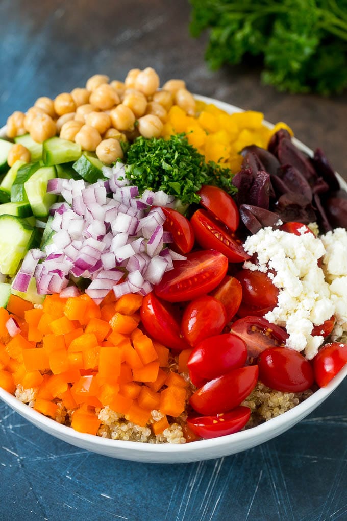 Cherry tomatoes, bell peppers, red onions, olives, feta and chickpeas over cooked quinoa.