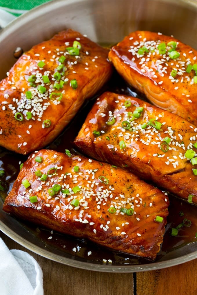 Salmon teriyaki fillets topped with sesame seeds and green onions.