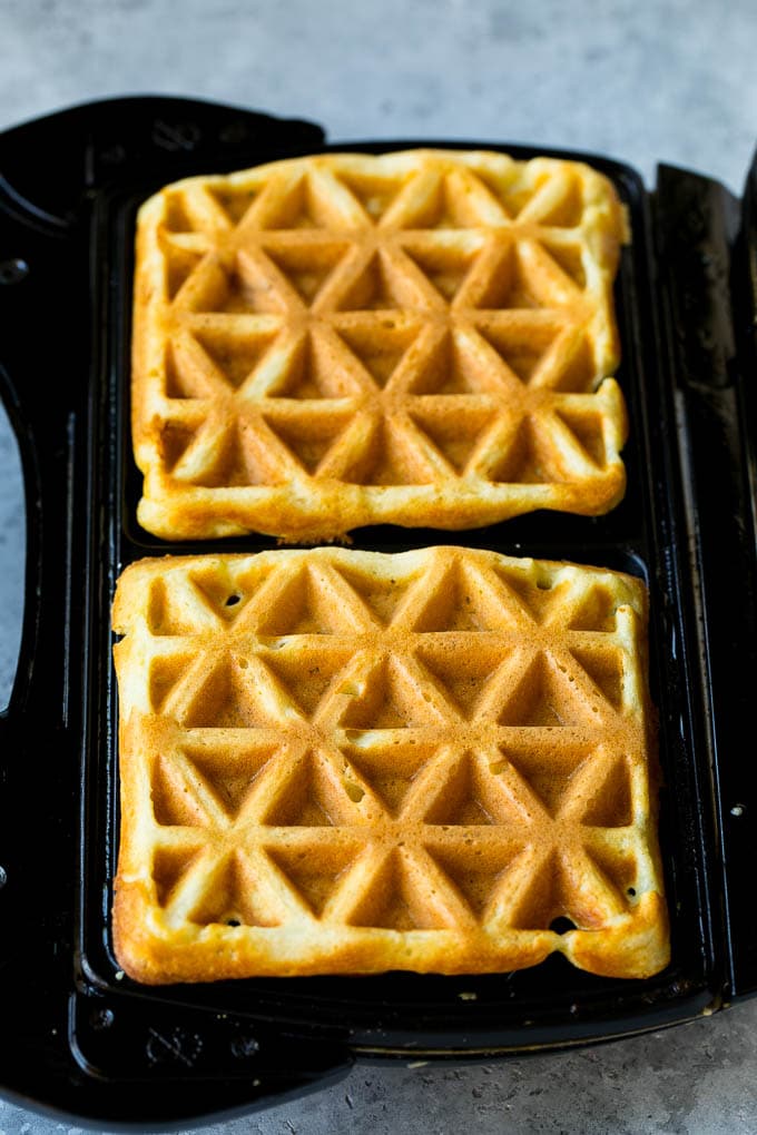 Waffles inside of a waffle iron.