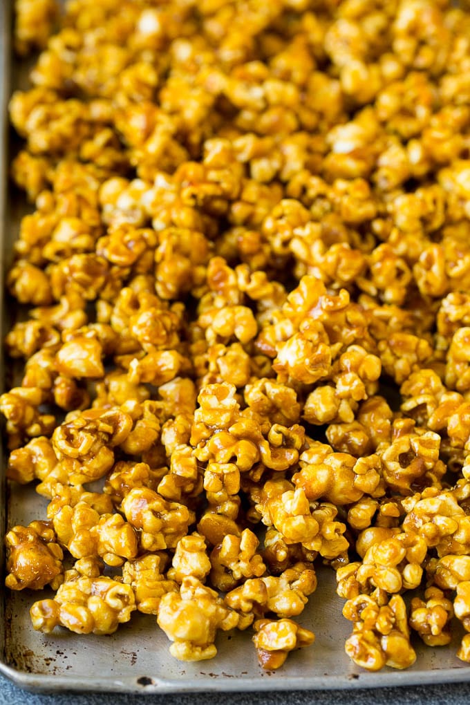 A sheet pan filled with caramel popcorn ready to eat.