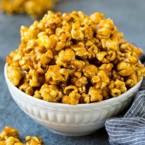 A serving bowl filled with caramel popcorn.