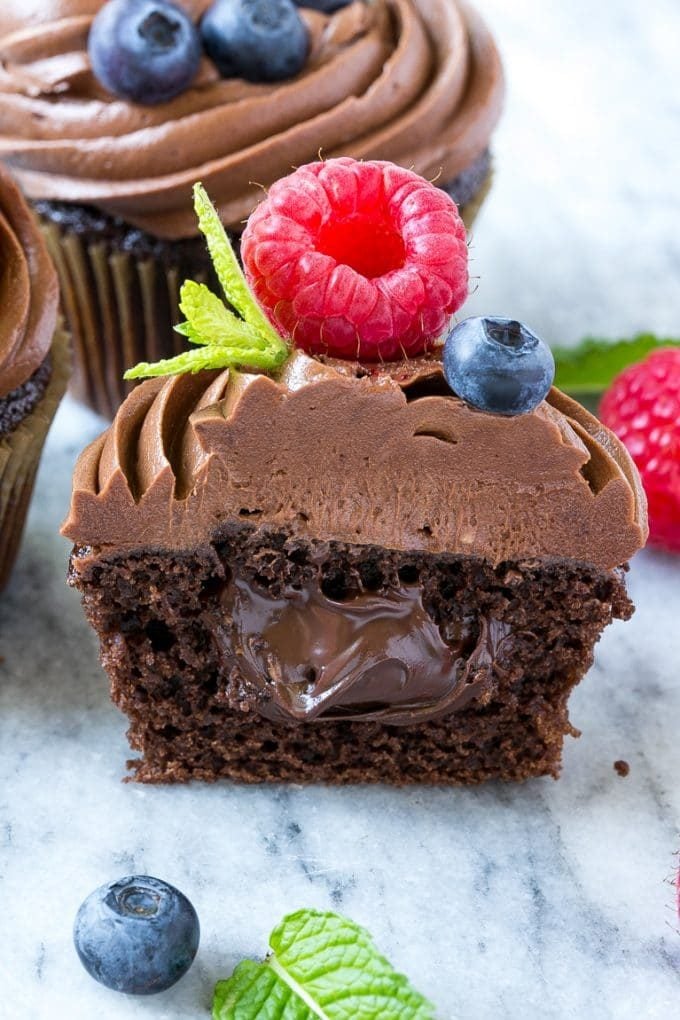 A cross section of a chocolate cupcake stuffed with Nutella.