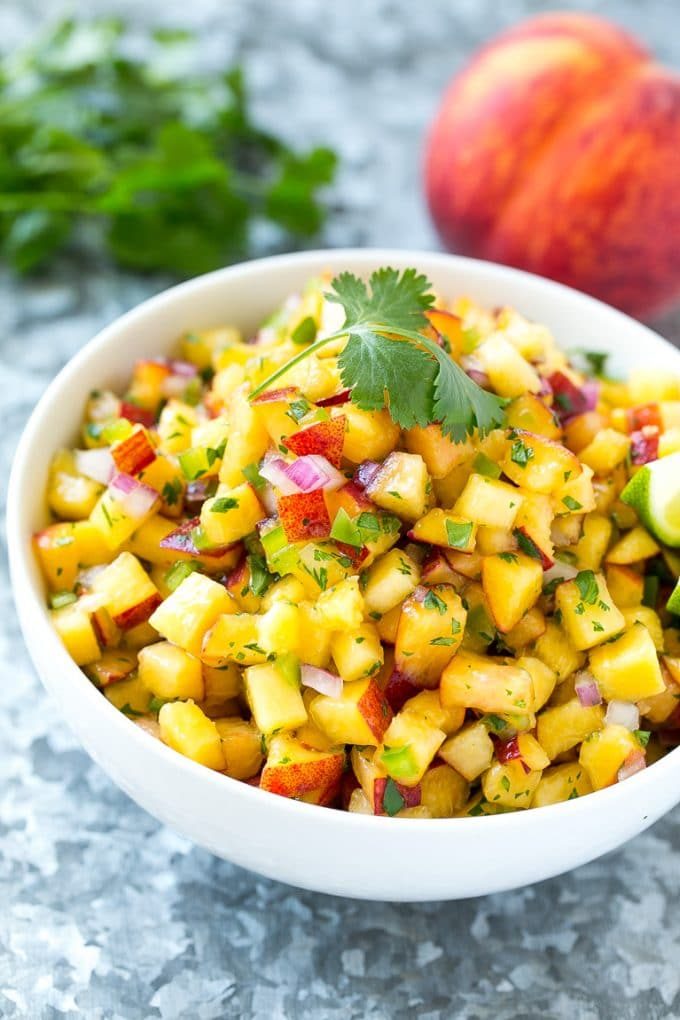 Peach salsa in a bowl made with red onion, jalapeno and cilantro.