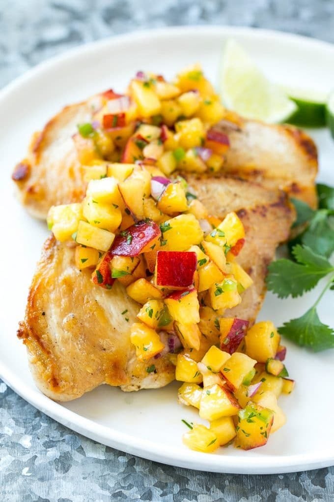 Peach salsa served over grilled chicken breast.