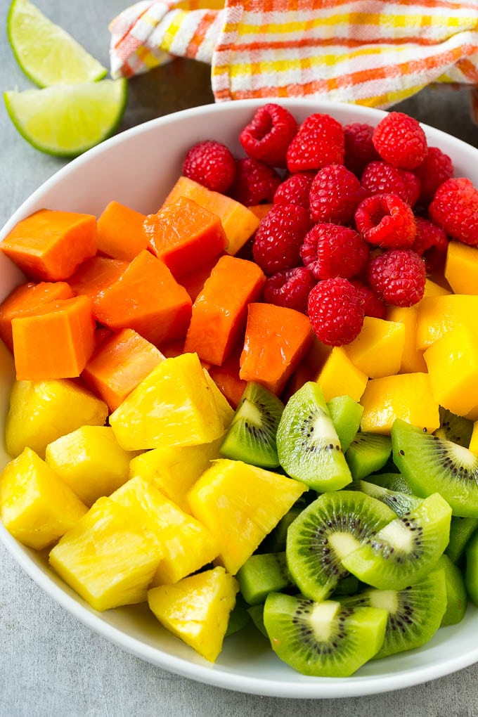 Pineapple, mango, kiwi, papaya and raspberries in a serving bowl.