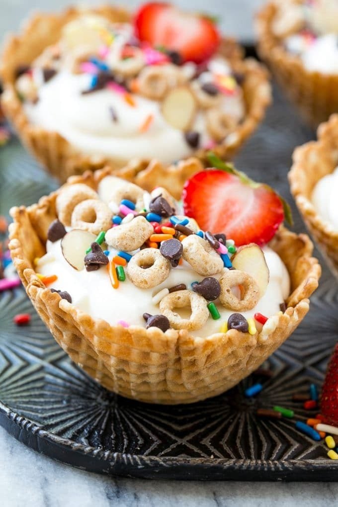 Breakfast sundaes made with waffle cone cups, yogurt, sprinkles and chocolate chips.