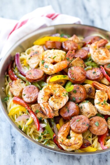This recipe for Cajun jambalaya pasta is full of andouille sausage, shrimp, Cajun spiced chicken and vegetables, all served over creamy pasta. A hearty meal that's perfect for an everyday dinner or for entertaining! #savoryoursummerrecipes #ad