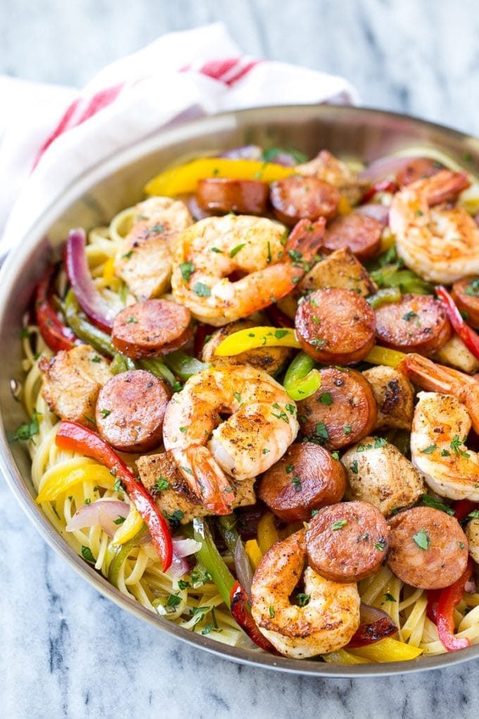 A pan of jambalaya pasta with shrimp, chicken, sausage and vegetables.