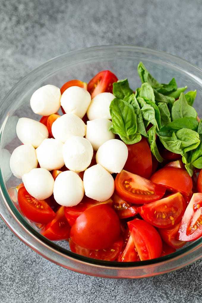 Tomatoes, mozzarella and basil in a bowl.