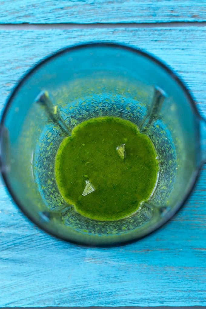Pureed cilantro sauce in a blender.