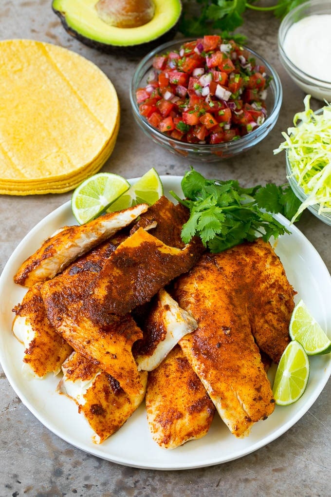 Cooked fish, cabbage, pico de gallo and corn tortillas.