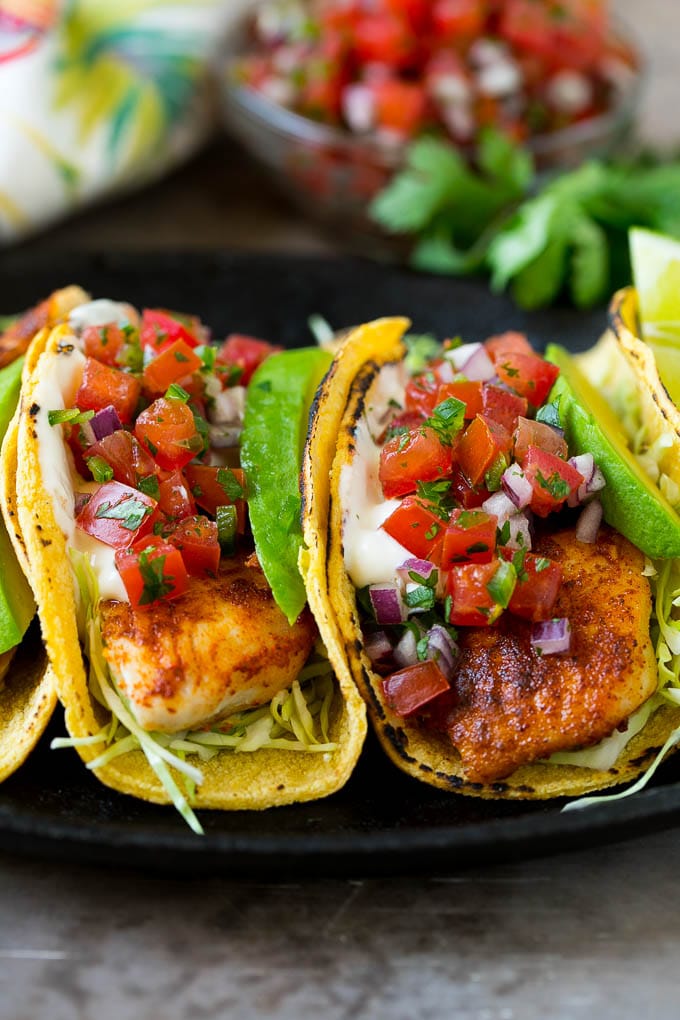 Fish tacos with cabbage, avocado, salsa and creamy sauce.