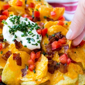 Irish nachos loaded with cheese, bacon, sour cream, tomatoes and chives.