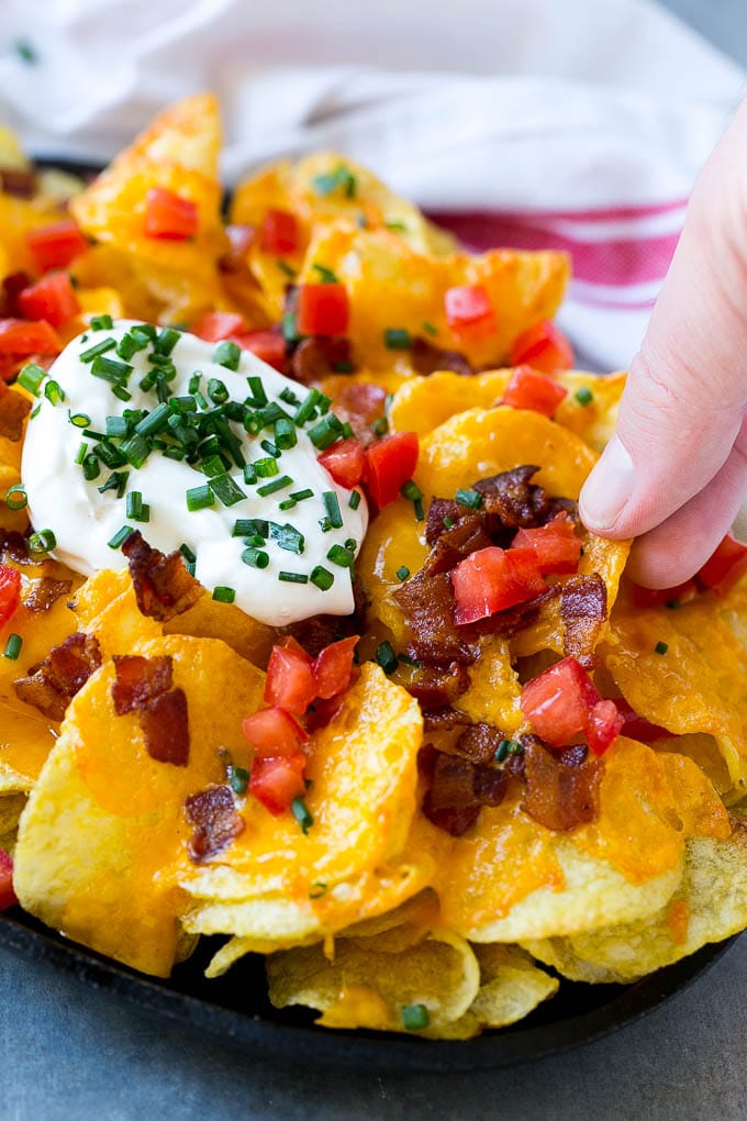 Irish nachos loaded with cheese, bacon, sour cream, tomatoes and chives.