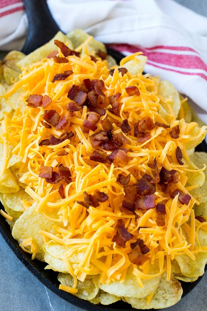 Kettle chips topped with shredded cheese and bacon.