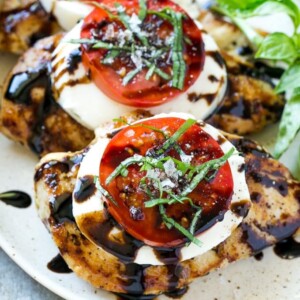 This recipe for chicken caprese is grilled seasoned chicken, topped with fresh mozzarella, ripe tomatoes, basil and balsamic reduction. A quick and easy dinner that's easy enough for a busy weeknight but special enough to serve to company!