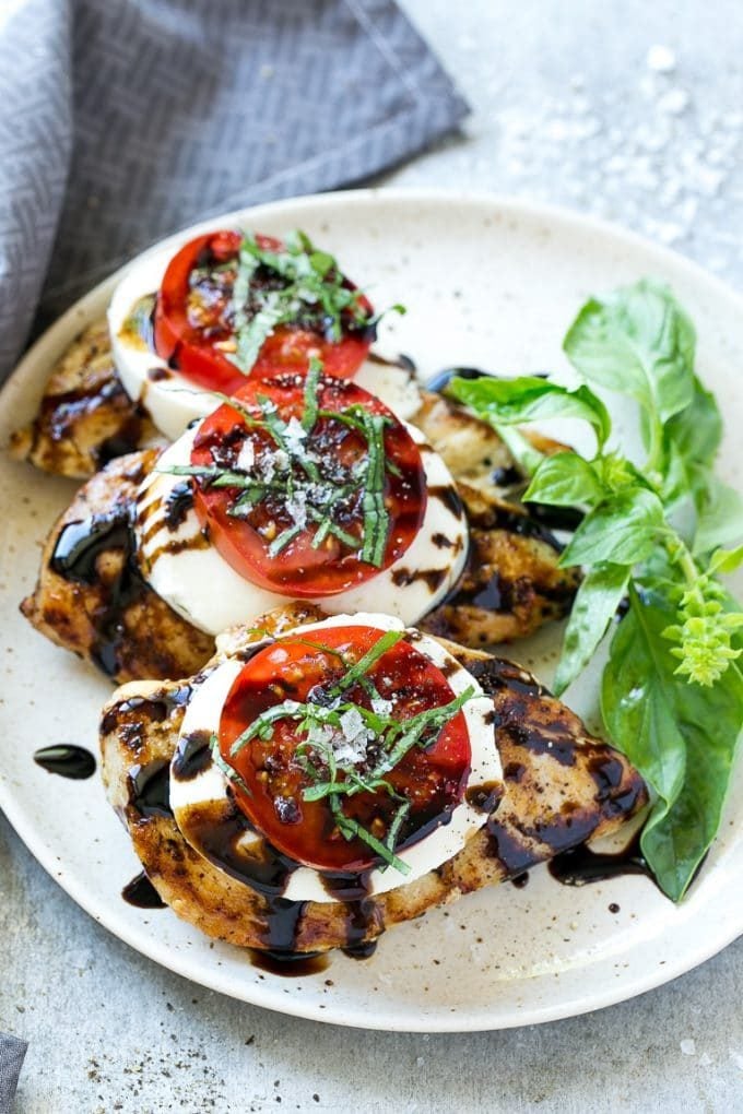 Grilled chicken caprese with tomato slices, balsamic reduction and finely chopped basil.
