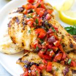 This recipe for Greek lemon chicken is marinated chicken that's been grilled to perfection and topped with a bright and delicious tomato and olive relish. The perfect dish for entertaining! #MyNewSaturday #GoogleExpress #ad