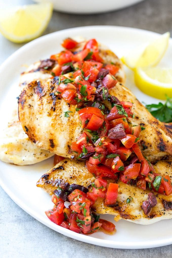 Greek lemon chicken breasts topped with tomato and olive relish.