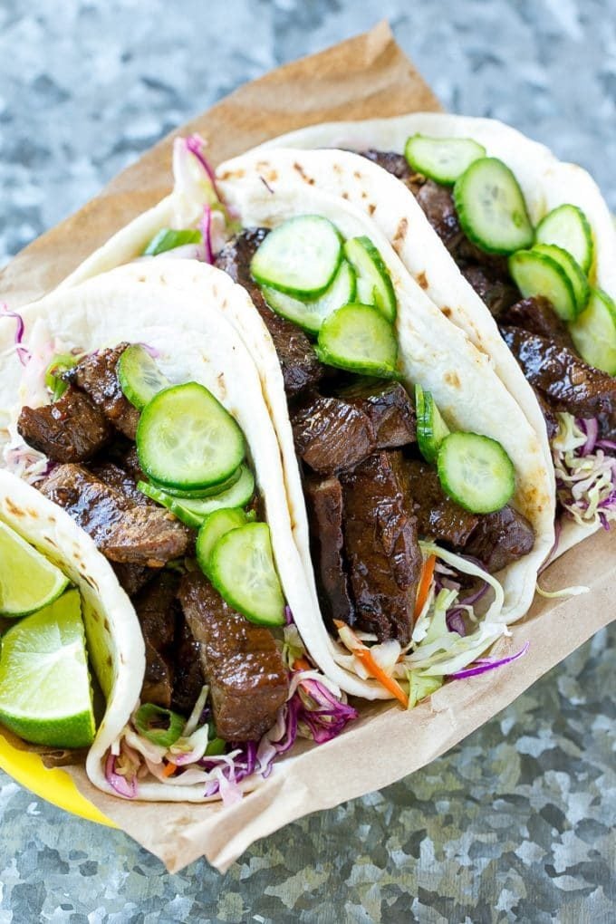 Asian style steak tacos with pickled vegetables in flour tortillas.