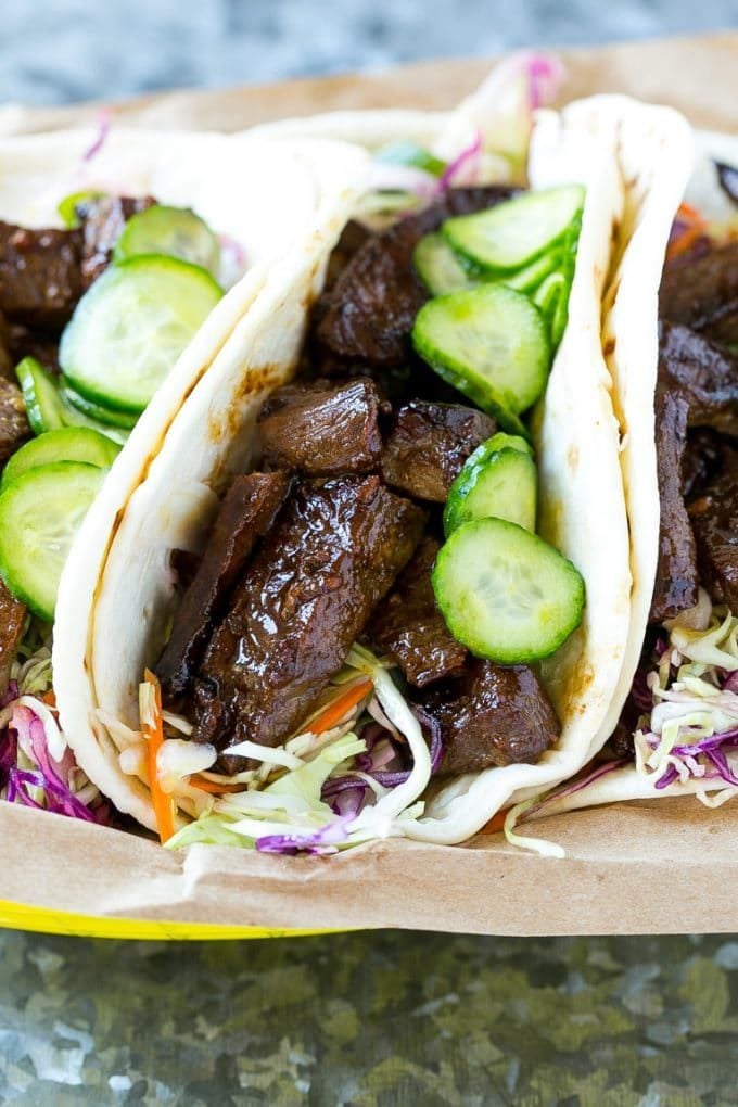 Korean BBQ tacos filled with marinated steak, shredded cabbage and pickled cucumbers.